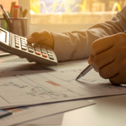 person with calculator and pen