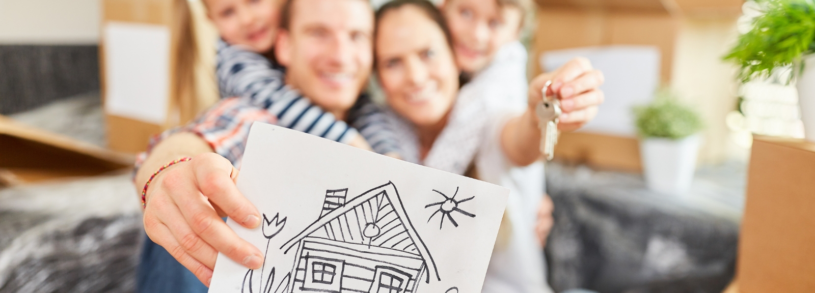 Family showing a drawing of a house