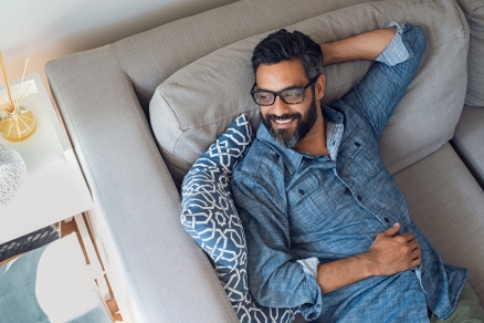 Man in blue shirt on couch