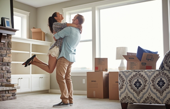 Happy couple hugging in new home. WyHy Home Loan Center