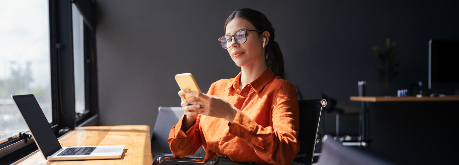 Woman using her phone to access Securian Financial’s My Coverage online claims portal.