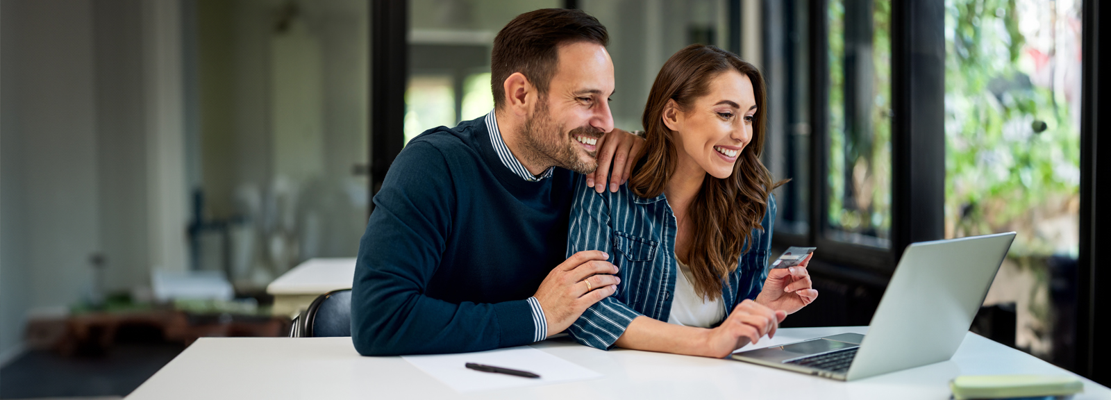 couple smiling at computer
