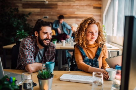 Two people looking at computer