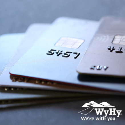 Stack of credit cards. Save on interest and transfer high-interest debt to a WyHy Visa® at 0% APR.
