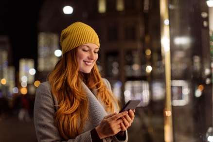 woman in street looking at phone